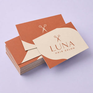 Matte Business Cards printed as a hair salon card, warm terracotta and cream with a small scissors mark