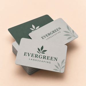 Soft Touch Business Cards printed as a landscaping card, forest green on pale grey with a small leaf mark