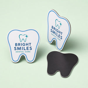 Cut to Shape Magnets 30mil printed as a tooth-shaped magnet for a dental practice with a small logo