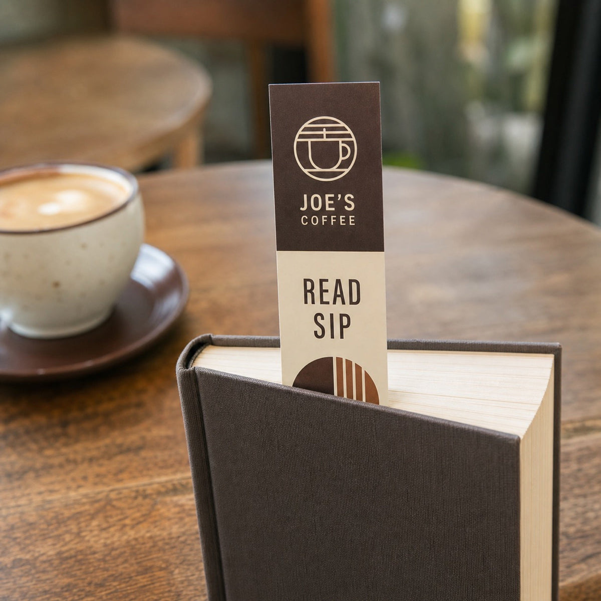 Economy Bookmarks in use - sticking out of the top of a closed novel on a cafe table