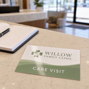 Economy Glossy Postcards in use - on a clinic reception desk beside an appointment book