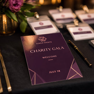 Glossy Invitations in use - on a registry desk at a charity gala with a pen beside it