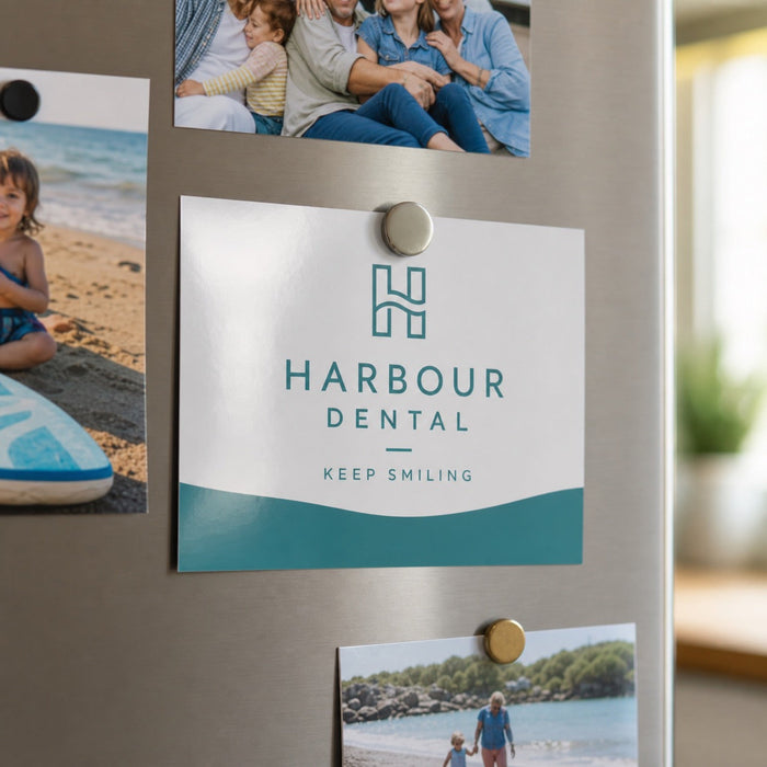 Glossy Postcards in use - pinned to a fridge door with a magnet among a few family photos