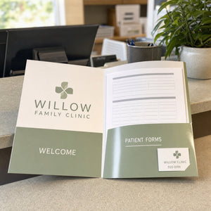 Glossy Presentation Folders in use - on a clinic reception desk with patient forms inside