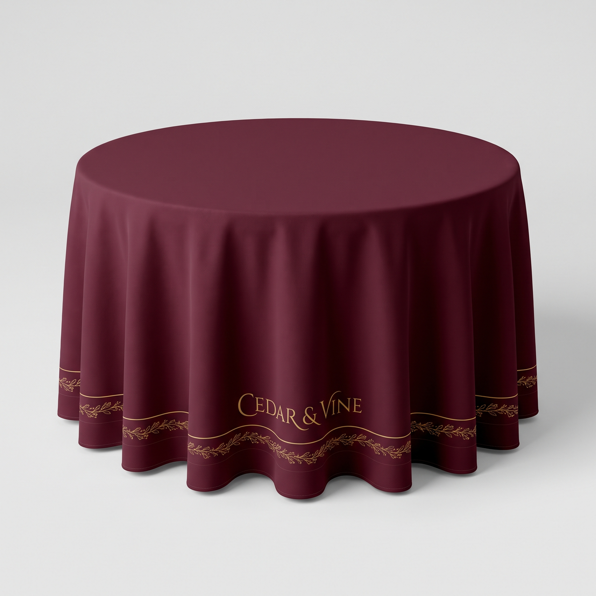 Custom printed round tablecloth on a 36 inch round table, burgundy with gold border and logo