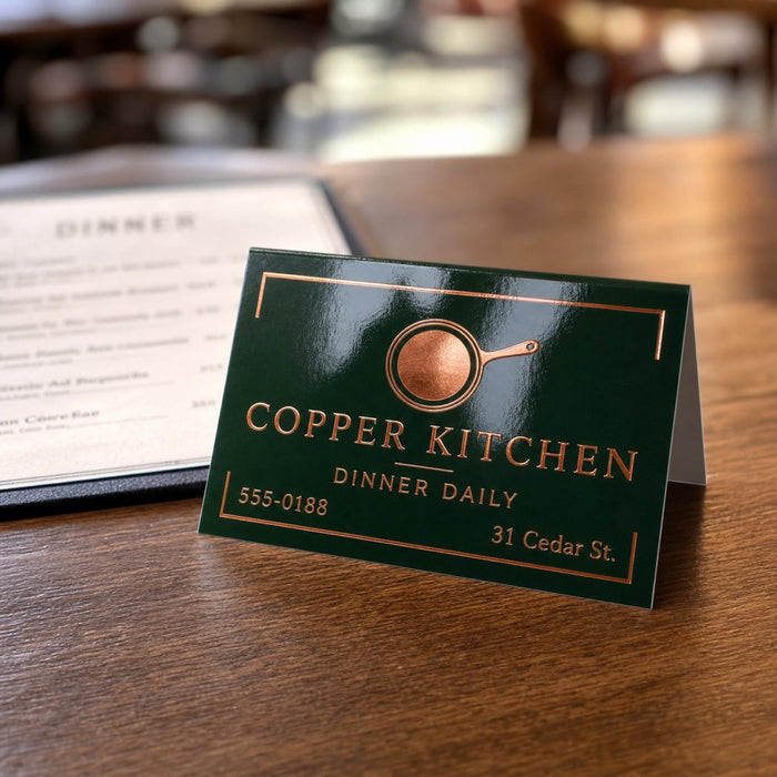 High-Gloss Folded Business Cards in use - standing open on a restaurant table beside a menu