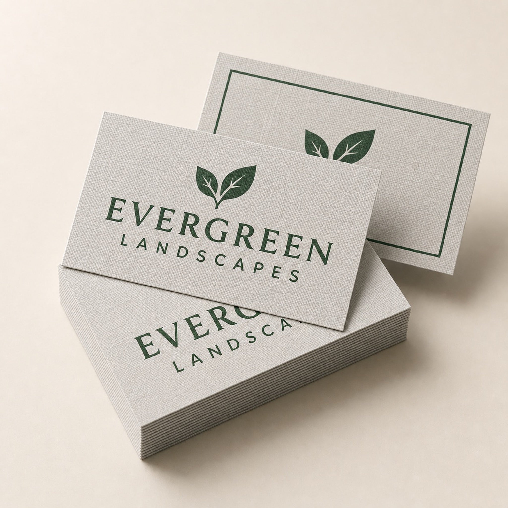 Linen Business Cards printed as a landscaping card, forest green on pale grey with a small leaf mark