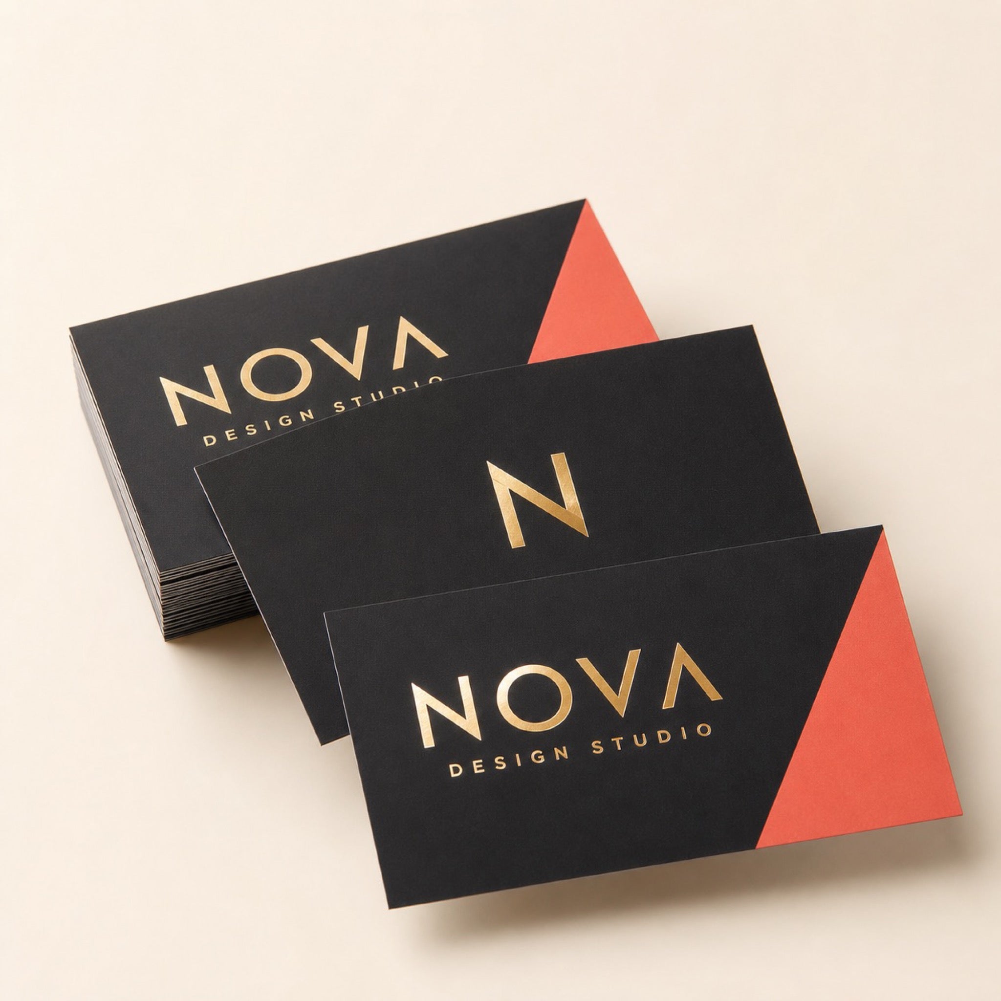 Metallic Foil Business Cards printed as a design studio card, black with one bright coral accent, very minimal