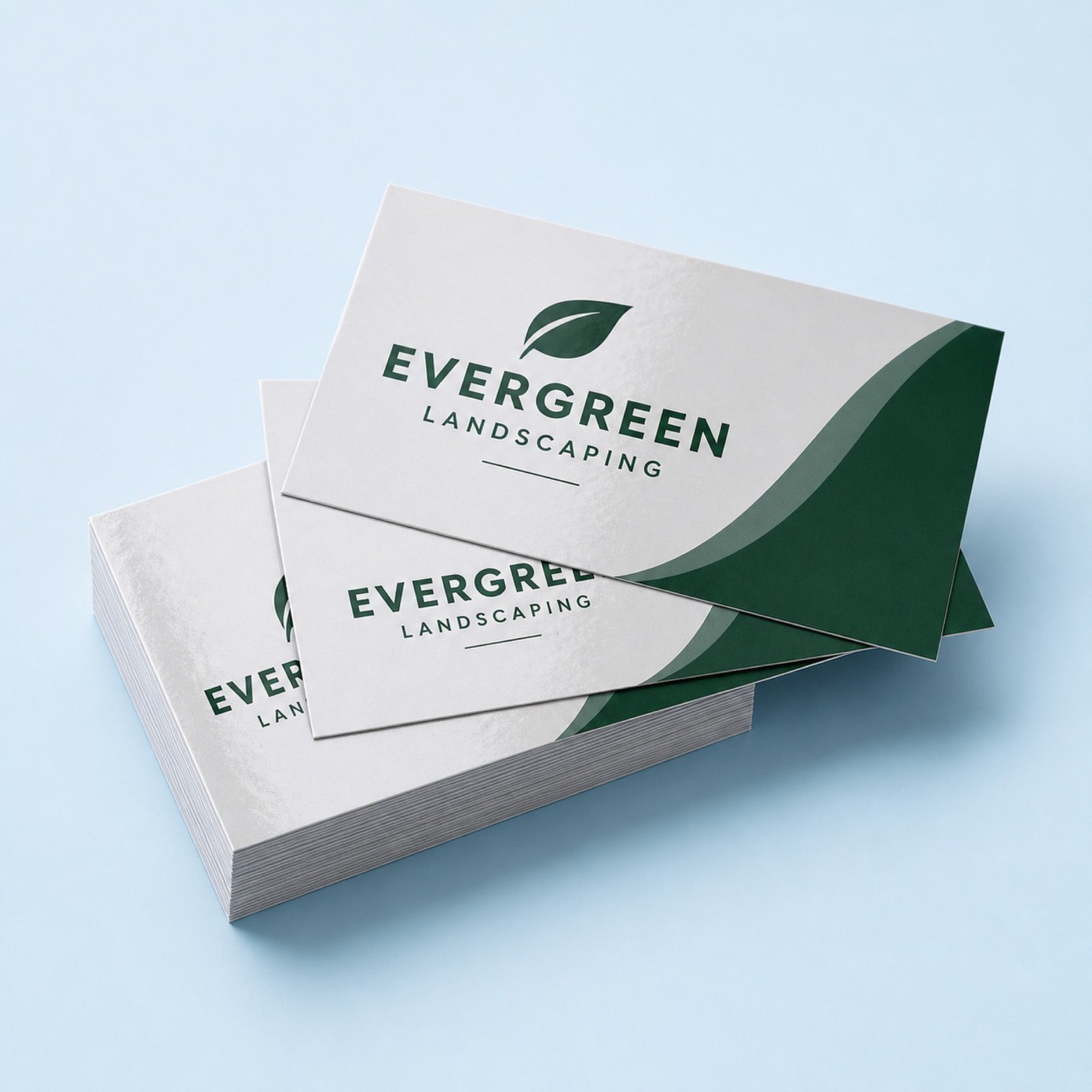 Premium Glossy Business Cards printed as a landscaping card, forest green on pale grey with a small leaf mark