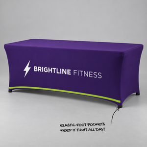 Custom printed stretch table cover on a 6 ft table with elastic foot pockets, purple Brightline Fitness print