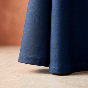 Close-up of the stitched bottom hem and woven polyester texture of a printed table throw