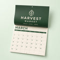 Wall Calendars printed on 80lb gloss text pages with a self cover, saddle stitched, 8.5 x 22 inches open, shown at an angle